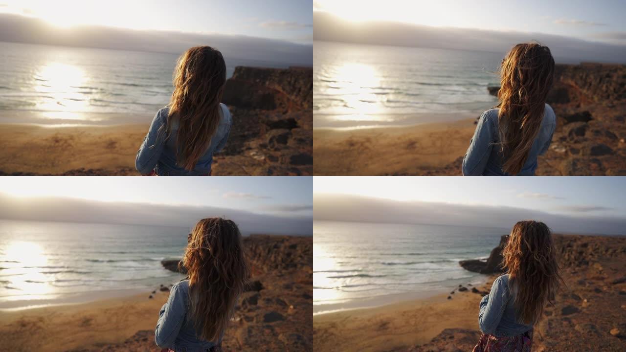 一个女人从悬崖边望向大海的特写镜头