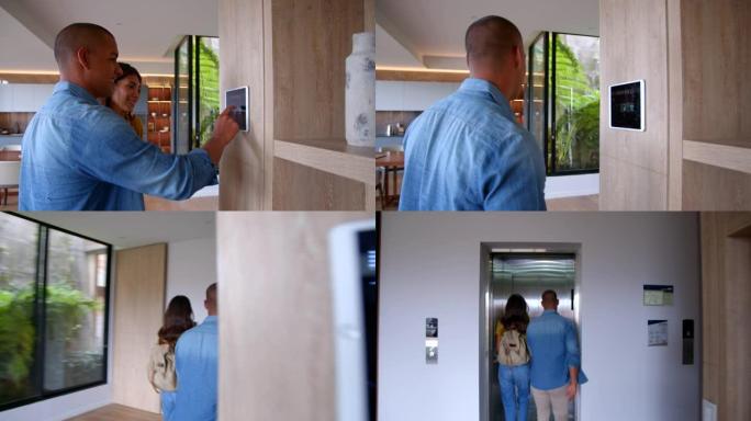 年轻的拉丁美洲夫妇离开他们的智能家居，激活平板电脑上的安全系统，手牵着手上电梯