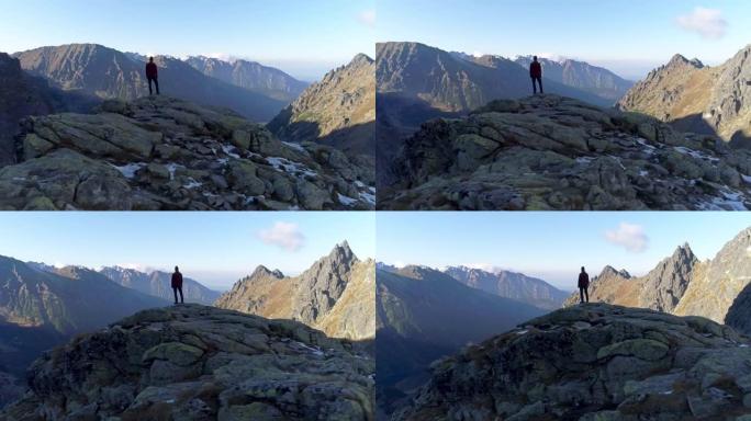 在世界之巅。登山者从山顶欣赏风景。无人机视图