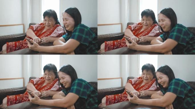 亚洲女性和她的母亲使用智能手机