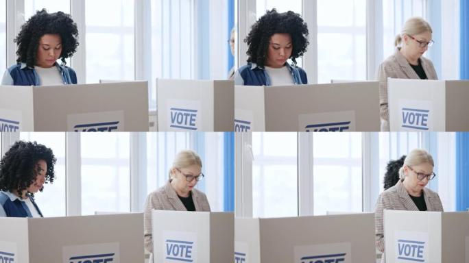 非裔美国妇女在投票站投票站投票，选票保密