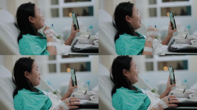 生病的亚洲妇女通过手机视频通话与朋友交谈