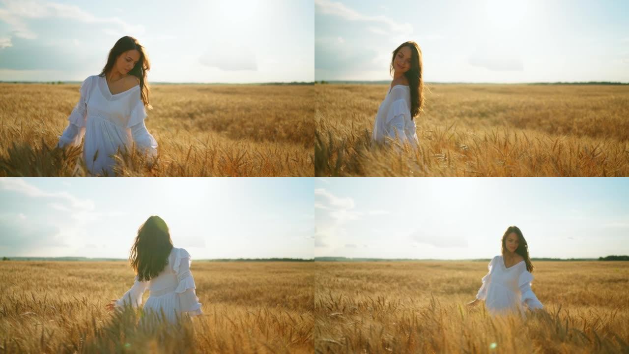 无忧无虑的乡村女人在夏天的金色麦田里玩得很开心，留着长发的漂亮女孩