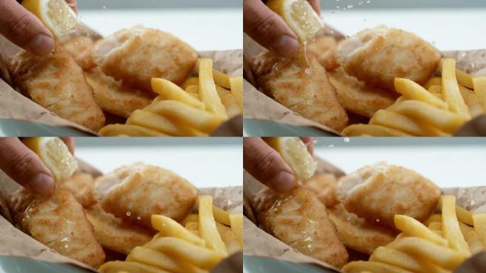 慢动作的柠檬炸鱼薯条。用幻影弹性4k相机拍摄。