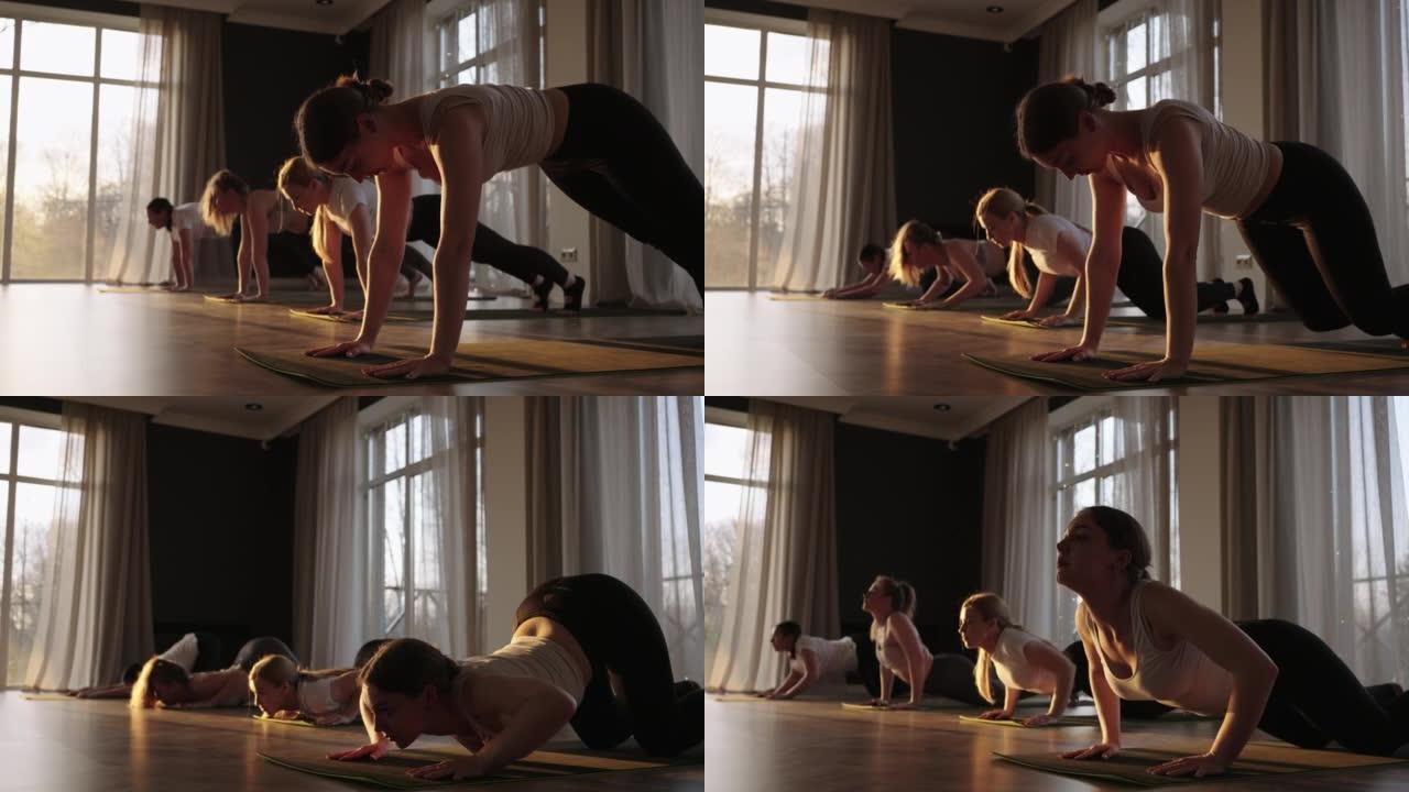 一群不同年龄的女性，胖瘦的，在日落时与教练一起以慢动作练习瑜伽。