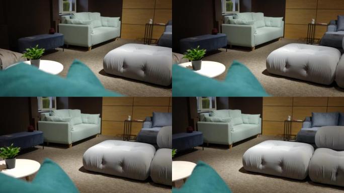 用舒适的柔软沙发在家具沙龙中左右平移。宽镜头现代豪华昂贵舒适沙发出售，室内无人。慢动作。
