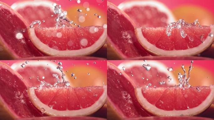 葡萄柚水通过葡萄柚切片飞溅的慢动作镜头