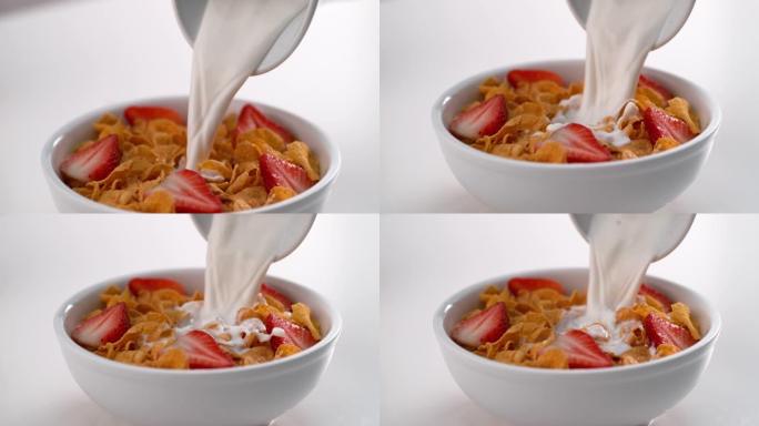 慢动作将牛奶倒入带有草莓的谷物中，在Phantom Flex 4k相机上拍摄。