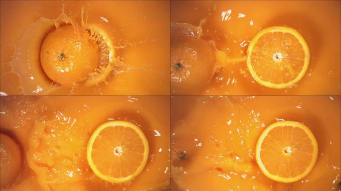 橙色水果随着飞溅落在果汁上，分成两半。