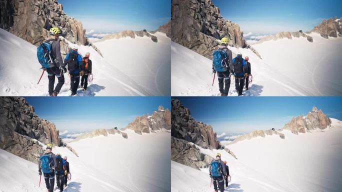 一队登山者沿着陡峭的山峰移动。冬季景观