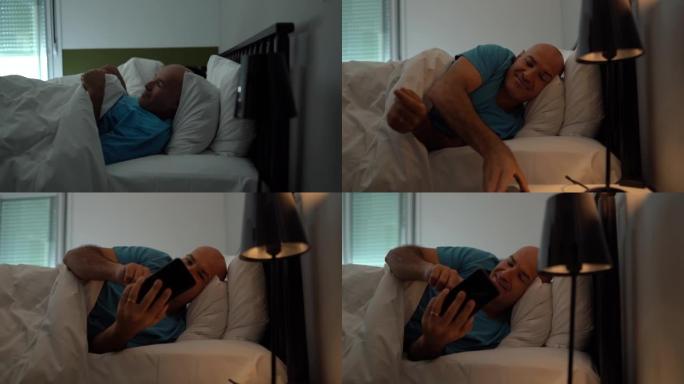 男子醒来并在家里的床上检查智能手机