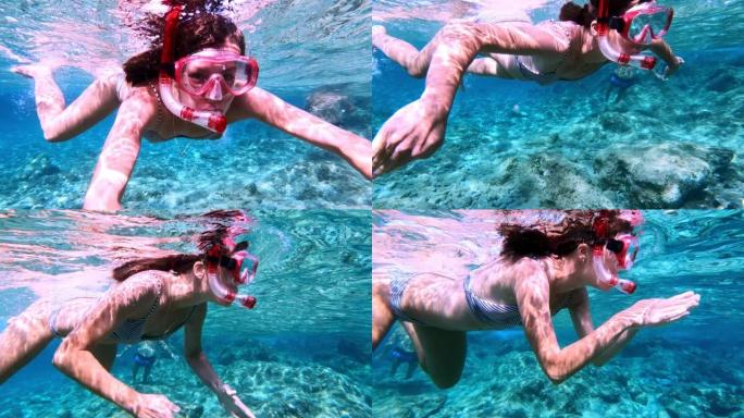 女人在海里浮潜。向可穿戴相机游泳