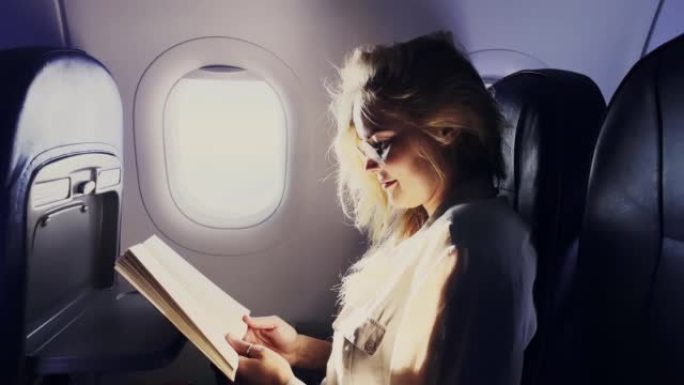 放松的女人在飞机上阅读