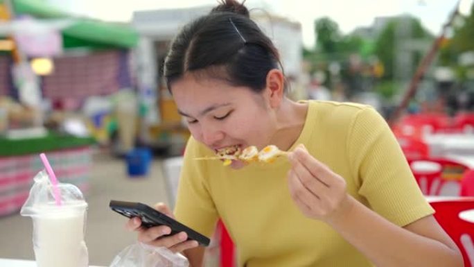 街头美食女人，泰国街头美食活动，吃得轻松。