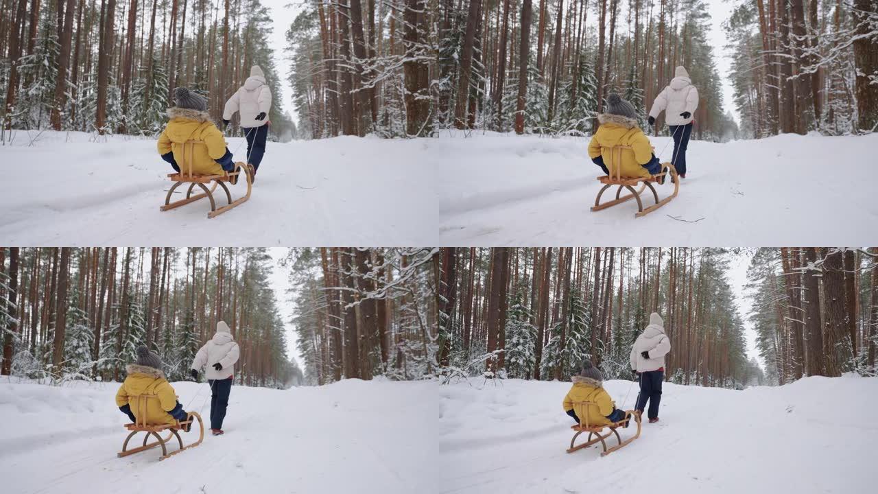 女人在冬天的森林里跑步，和她的小儿子拉雪橇，幸福的家庭周末