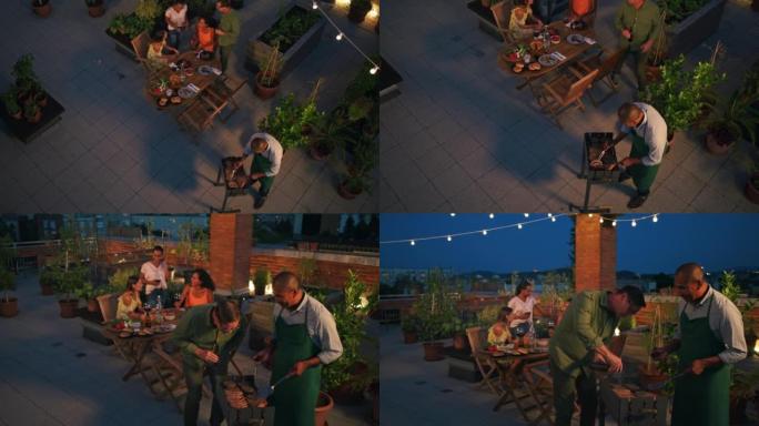CS人晚上在城市的屋顶烧烤聚会上聊天并玩乐