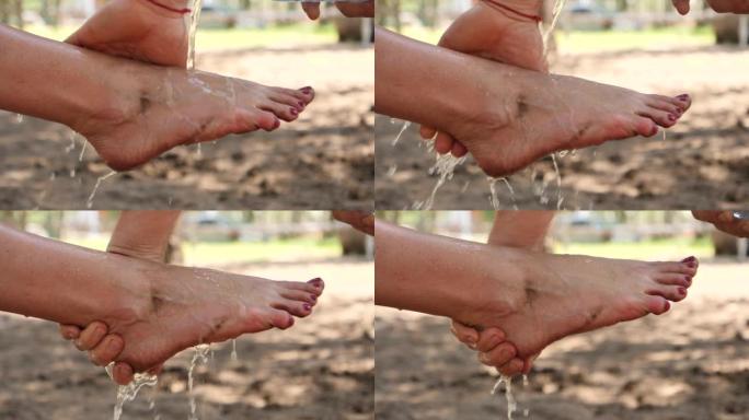 特写镜头男子用手擦洗妻子倒水的脏脚