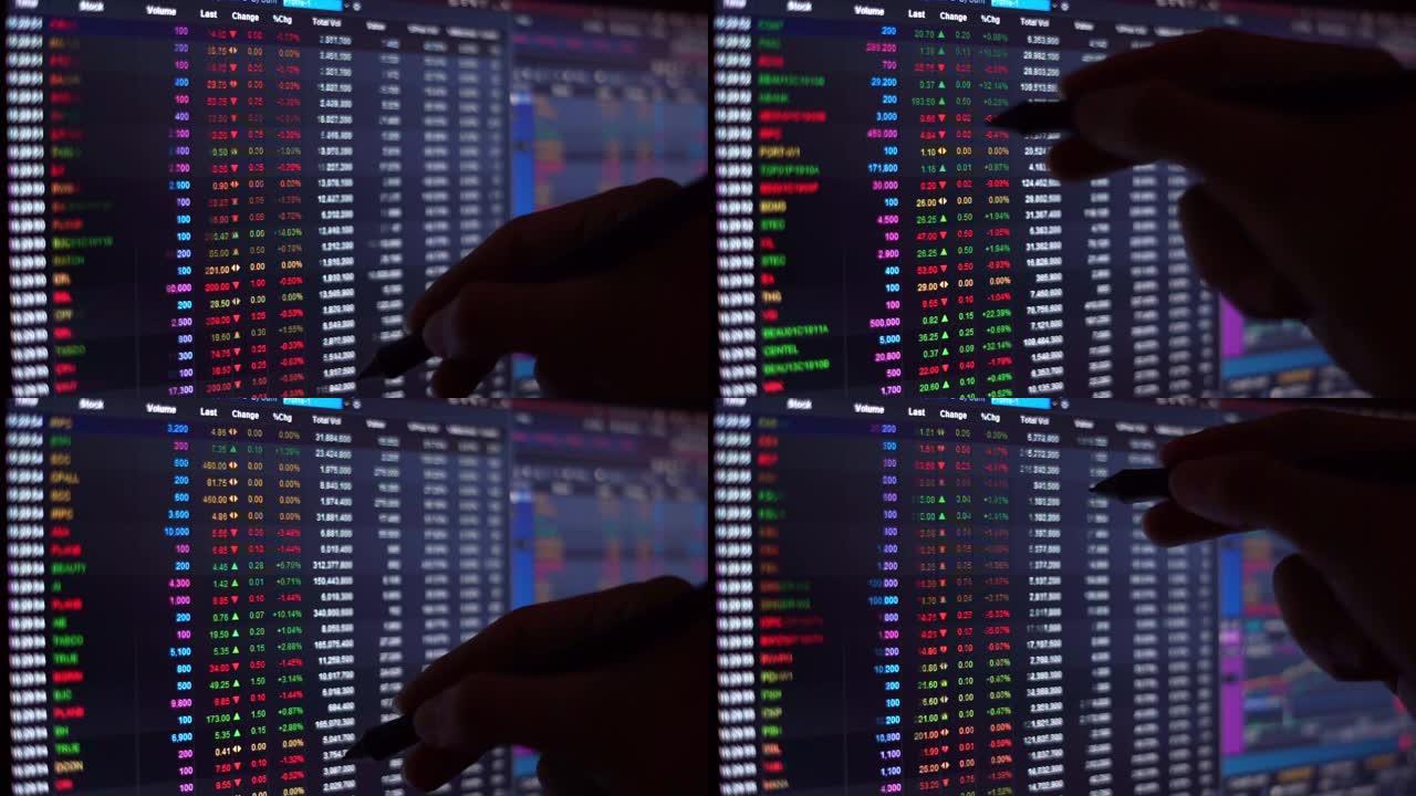 黑色监视器背景上的股市行情盘上移动手握笔查找数字的财务图表