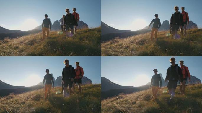 一群朋友在日落的山上徒步旅行