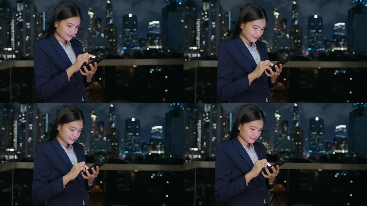 亚洲女商人在办公室的阳台上使用移动互联网。