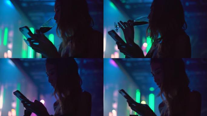 在夜总会使用智能手机的女人