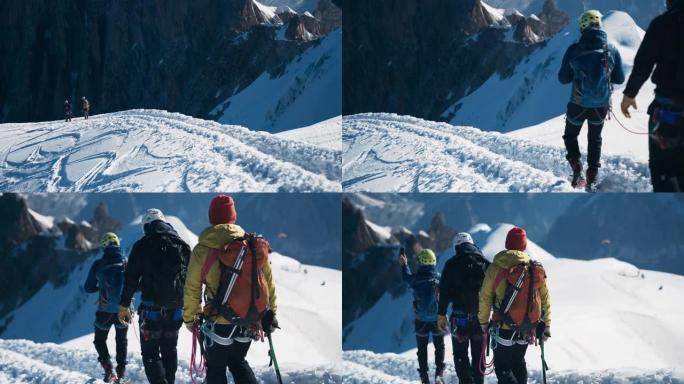 一队登山者沿着陡峭的山峰移动。使用绳索和攀爬设备