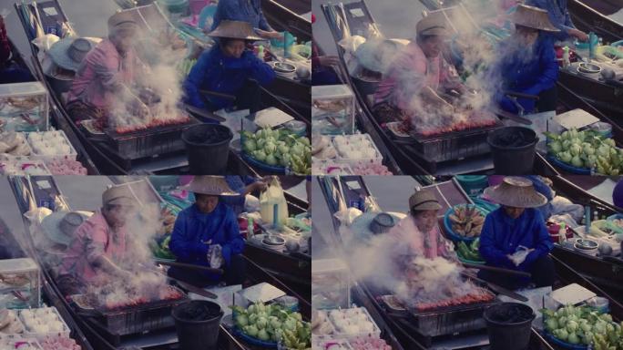 人们在泰国浮动市场烹饪食物