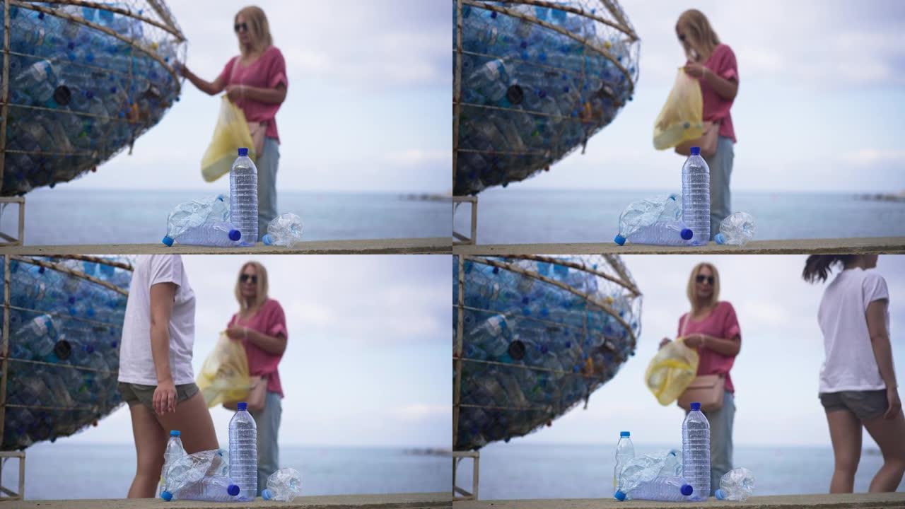 模糊的女人把塑料垃圾放在海滩海岸的特殊地方，因为难以辨认的千禧一代在前面经过，把空瓶子放在一边。生活