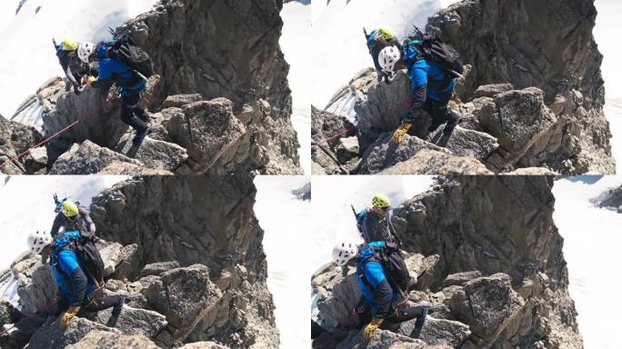 一队登山者沿着陡峭的墙壁移动。高海拔山脉