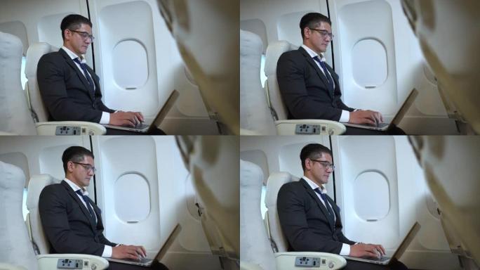 商人在飞行中使用笔记本电脑