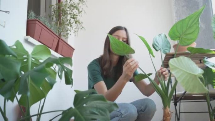 年轻女子倾向于在公寓外种植植物