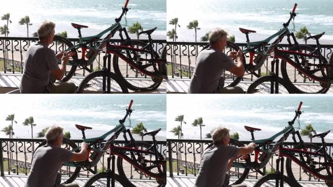 男子在海滨露台上修理自行车