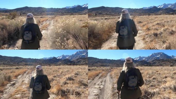 女徒步旅行者遵循沙漠路线