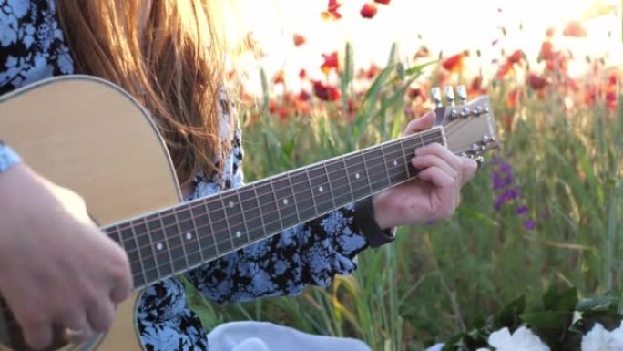 女人喜欢在大自然的日落日在阳光下弹吉他。