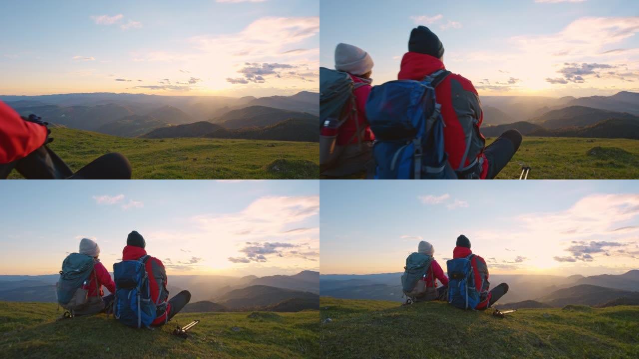 SLO MO CS夫妇在山顶上放松并观看日落