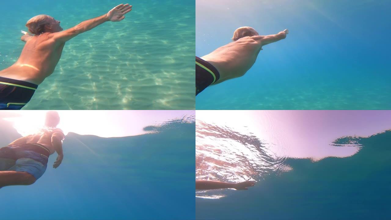 男子在清澈的地中海中游泳