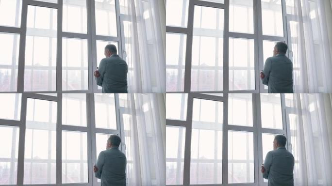 中年人看着窗外感到孤独，不开心