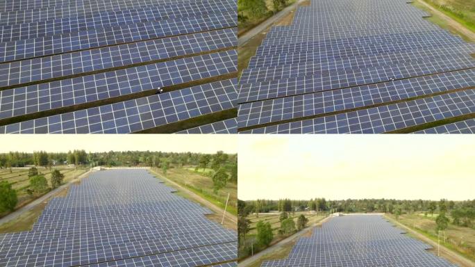 从阳光下鸟瞰太阳能电池的技术工程师，检查太阳能发电场的太阳能电池板。