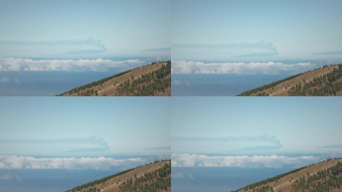 从邻近岛屿看到的Cumbre Vieja的遥远喷发。火山峰上方的烟雾
