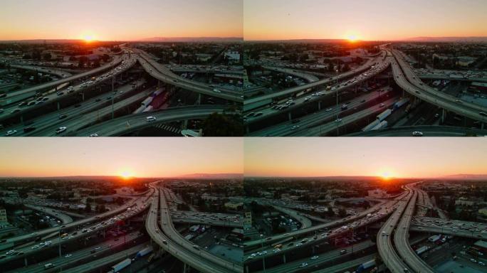 日落时加利福尼亚州洛杉矶10号州际公路和110号高速公路上的交通上升鸟瞰图