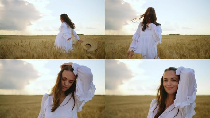 穿着白色连衣裙的黑发女人在夏天的金色黑麦田野上旋转，幸福无忧无虑