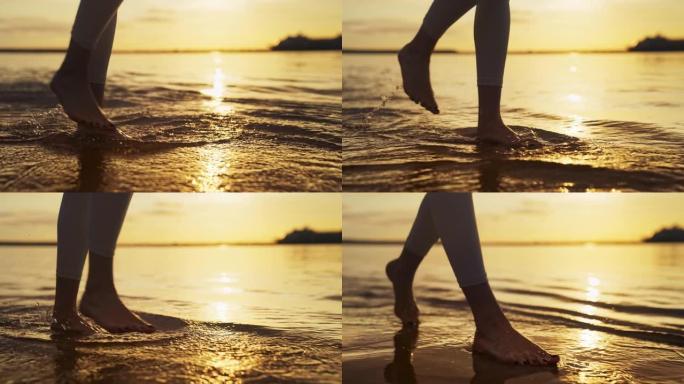 海滨慢跑训练。享受日落和自由的女人。赤脚走在潮湿的沙滩上