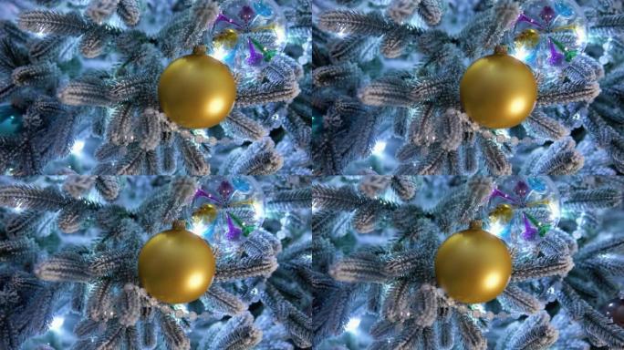 传统人造圣诞树，背景为金球装饰和发光七彩灯