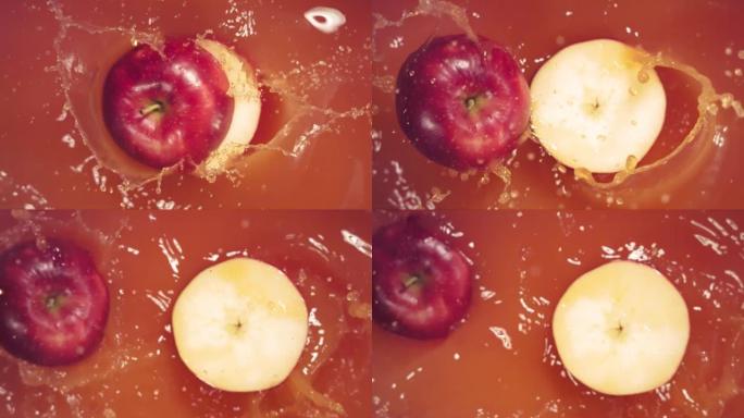 红苹果随着飞溅落在果汁上，分成两半。
