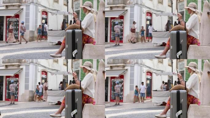 一位旅行妇女提着手提箱在五彩广场休息