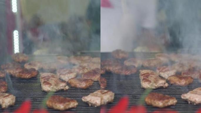 在烤架上烹饪肉类的垂直细节照片