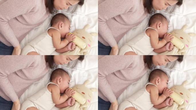 初生婴儿或可爱的小家伙躺在家里的白色床上微笑。婴儿儿童肖像快乐概念，早上健康育儿。