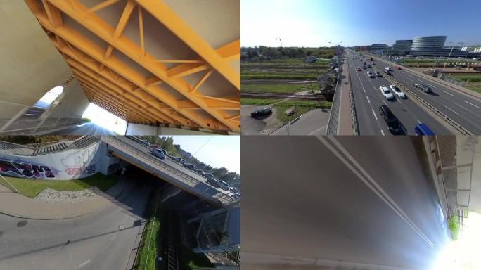 FPV无人机在四车道的大立交桥周围飞行。城市景观杂技
