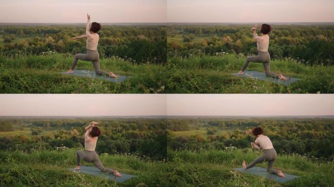 在慢动作中，一名年轻女子通过在顶部进行平衡和伸展来进行瑜伽练习。身体和灵魂的平静与和平平衡。身体弯曲