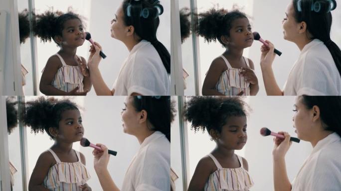 亚洲年轻母亲为她的混血非裔亚洲女儿化妆